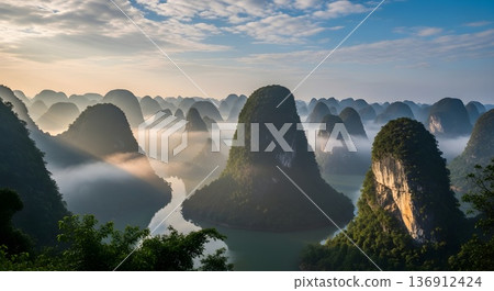 Karst towers in morning mist in morning light with scattered clouds tight composition 136912424
