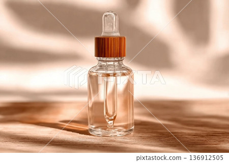 Natural oil cosmetics. Dropper glass Bottle Mock-Up. Oily cosmetic pipette. Face and body treatment. Spa concept. Mineral organic liquid. Front view. Beauty products. Blank packaging on wooden table. Natural oil cosmetics. Dropper glass Bottle Mock-Up. Oily cosmetic pipette. Face and body treatment. Spa concept. Mineral organic liquid. Front view. Beauty products. Blank packaging on wooden table. 136912505