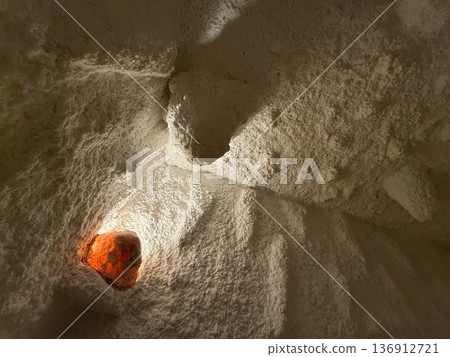 Salt therapy cave interior with mineral ceiling formations and recessed lighting. Holistic wellness space, relaxation ritual and natural health environment 136912721