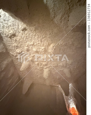 Salt therapy cave interior with mineral ceiling formations and recessed lighting. Holistic wellness space, relaxation ritual and natural health environment Salt therapy cave interior with mineral ceiling formations and recessed lighting. Holistic wellness space, relaxation ritual and natural health environment 136912734