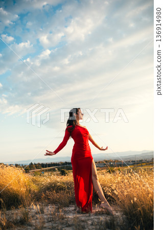 Joyful woman in red dress under a bright sky in Sicily, Italy Joyful woman in red dress under a bright sky in Sicily, Italy 136914980