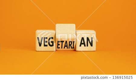 Vegetarian or vegan symbol. Concept words Vegetarian Vegan on wooden block. Beautiful orange table orange background. Healthy lifestyle vegetarian or vegan concept. Copy space. Vegetarian or vegan symbol. Concept words Vegetarian Vegan on wooden block. Beautiful orange table orange background. Healthy lifestyle vegetarian or vegan concept. Copy space. 136915025