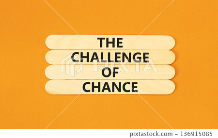 The challenge of chance symbol. Concept words phrase The challenge of chance on beautiful wooden stick. Beautiful orange paper background. Business The challenge of chance concept. Copy space. The challenge of chance symbol. Concept words phrase The challenge of chance on beautiful wooden stick. Beautiful orange paper background. Business The challenge of chance concept. Copy space. 136915085