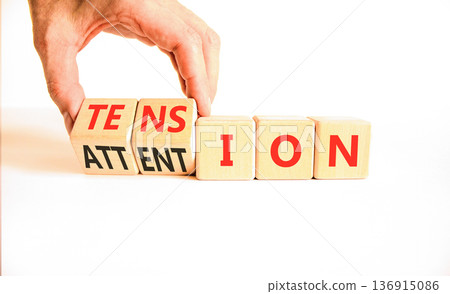 Tension or attention symbol. Concept words Attention or Tension on beautiful wooden blocks. Beautiful white background. Businessman's hand. Business tension or attention concept. Copy space. 136915086