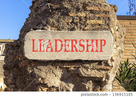 Leadership symbol. Concept word Leadership on beautiful white marble sign plate. Beautiful ancient brick wall background. Business leadership concept. Copy space. 136915185