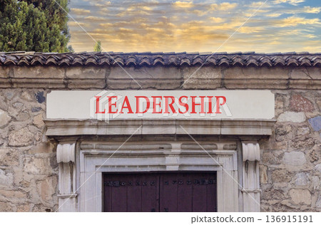 Leadership symbol. Concept word Leadership on beautiful white marble sign plate. Beautiful ancient stone wall and sunset background. Business leadership concept. Copy space. Leadership symbol. Concept word Leadership on beautiful white marble sign plate. Beautiful ancient stone wall and sunset background. Business leadership concept. Copy space. 136915191