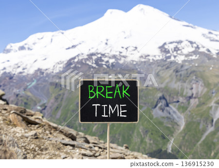 Break time symbol. Concept word Break time on beautiful black blackboard. Beautiful stone mountain Elbrus blue sky background. Black blackboard. Business break time concept. Copy space. Break time symbol. Concept word Break time on beautiful black blackboard. Beautiful stone mountain Elbrus blue sky background. Black blackboard. Business break time concept. Copy space. 136915230