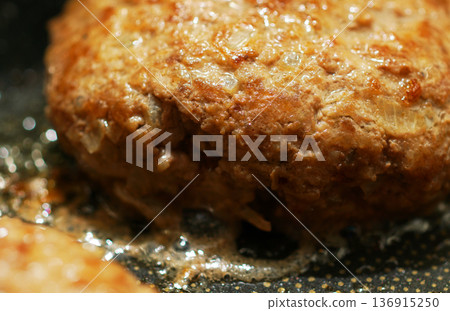 Cooking hand-made hamburger steak in a frying pan Cooking hand-made hamburger steak in a frying pan 136915250