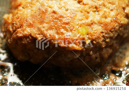 Cooking hand-made hamburger steak in a frying pan 136915258