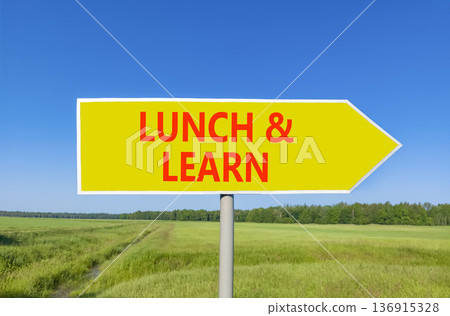 Lunch and learn symbol. Concept words Lunch and learn on beautiful yellow road sign. Beautiful blue sky green grass field background. Business, educational and lunch and learn concept. Copy space. 136915328