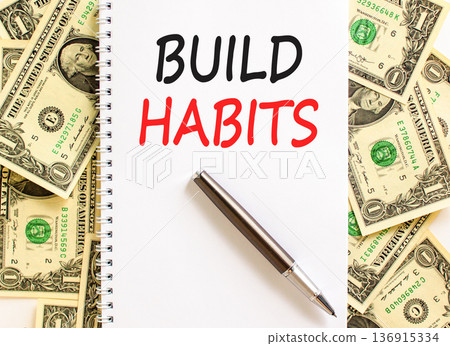 Build habits symbol. Concept word Build habits on beautiful white note. Dollar bills. Beautiful dollar bills background. Black pen. Business build habits concept. Copy space. Build habits symbol. Concept word Build habits on beautiful white note. Dollar bills. Beautiful dollar bills background. Black pen. Business build habits concept. Copy space. 136915334