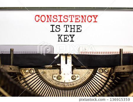 Consistency is the key symbol. Concept words Consistency is the key typed on beautiful old retro typewriter. Beautiful white paper background. Business consistency is the key concept. Copy space. 136915359