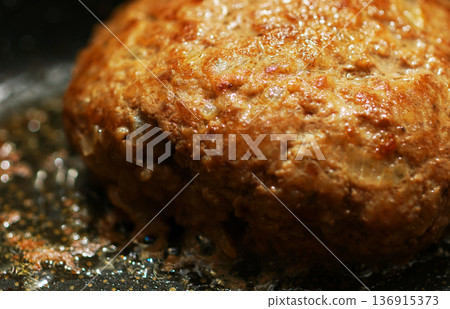 Cooking hand-made hamburger steak in a frying pan 136915373