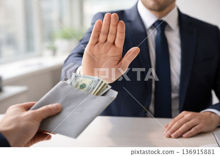 Businessman refusing bribe envelope with cash corruption and anti bribery concept Businessman refusing bribe envelope with cash corruption and anti bribery concept 136915881