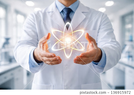 Scientist holding glowing atom symbol representing science innovation and research 136915972
