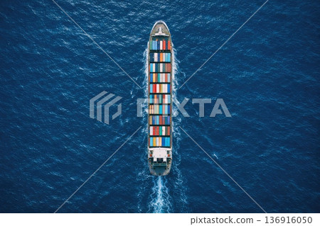 Aerial view of container cargo ship sailing across deep blue ocean Aerial view of container cargo ship sailing across deep blue ocean 136916050