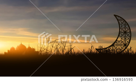 A beautiful silhouette of a mosque and an ornate crescent moon in a field during a vibrant golden sunset. Ideal for Ramadan Kareem, Eid Mubarak, and Islamic religious celebrations 136916593