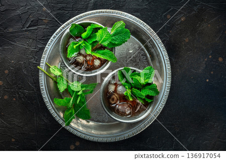 Mint Julep in the Kentucky Derby classic silver glass, with fresh mint leaves Mint Julep in the Kentucky Derby classic silver glass, with fresh mint leaves 136917054