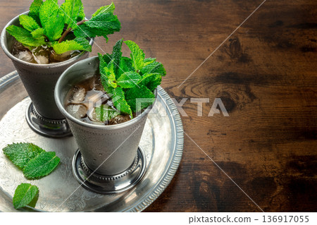 Mint Julep in the Kentucky Derby classic silver glass, with fresh , on a tray 136917055