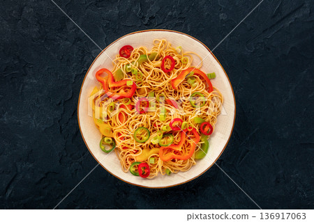 Hakka noodles with vegetables, peppers and green onions, overhead shot Hakka noodles with vegetables, peppers and green onions, overhead shot 136917063