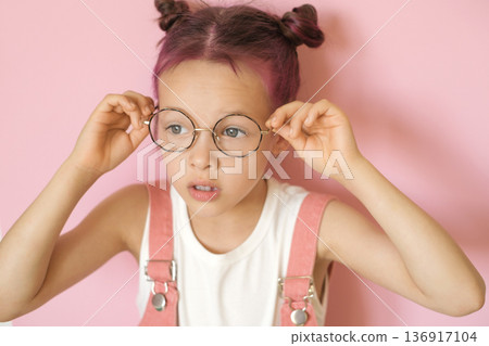 The girl puts on her eyeglasses and is surprised at her clear vision. World Sight Day The girl puts on her eyeglasses and is surprised at her clear vision. World Sight Day 136917104