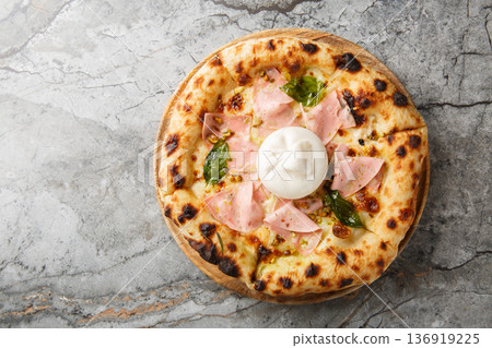 Mortadella and burrata pizza with basil and pistachios close-up on a wooden board. Horizontal top view Mortadella and burrata pizza with basil and pistachios close-up on a wooden board. Horizontal top view 136919225