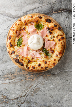 Authentic Italian pizza with mortadella sausage and burrata cheese, close-up, on a wooden board. Vertical top view Authentic Italian pizza with mortadella sausage and burrata cheese, close-up, on a wooden board. Vertical top view 136919228