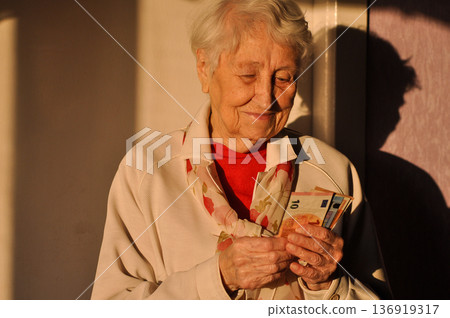 gray hair pretty woman with bills 136919317