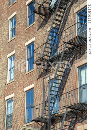 Rusty fire escapes on a renovated brick building. Rusty fire escapes on a renovated brick building. 136919508