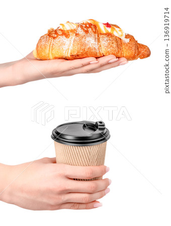 Croissant and takeaway coffee in hands isolated on white background 136919714