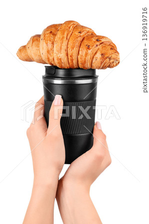 Reusable coffee cup with croissant in female hands Reusable coffee cup with croissant in female hands 136919716