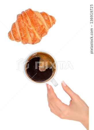 Croissant and cup of black coffee with female hand isolated on white background 136919725