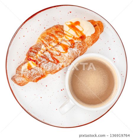 Top view croissant with cream and caramel on plate with coffee Top view croissant with cream and caramel on plate with coffee 136919764