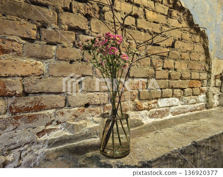 A vase of flowers sits on a brick wall, design element A vase of flowers sits on a brick wall, design element 136920377