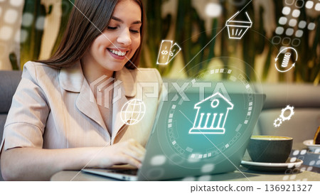 Woman using laptop for online banking invoice payment at a cafe in the afternoon 136921327
