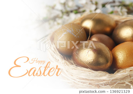 Happy Easter celebration with golden eggs in a nest on spring morning 136921329