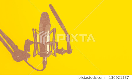 Podcast microphone setup with yellow background for recording sessions 136921387