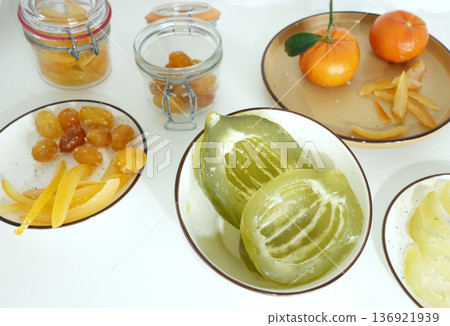 Preparing candied citrus fruits for jars. Sweets and traditional food in Italy. Kumquats, orange peels, and citron. Seasonal, high-quality European farm products. Preparing candied citrus fruits for jars. Sweets and traditional food in Italy. Kumquats, orange peels, and citron. Seasonal, high-quality European farm products. 136921939