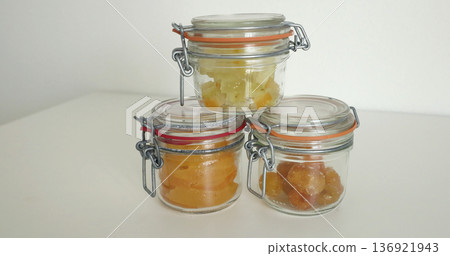 Preparing candied citrus fruits for jars. Sweets and traditional food in Italy. Kumquats, orange peels, and citron. Seasonal, high-quality European farm products. 136921943
