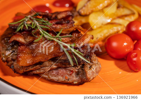 Steak with fried potatoes and tomatoes on a plate Steak with fried potatoes and tomatoes on a plate 136921966