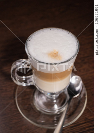 Latte in a glass cup on a wooden table 136921991