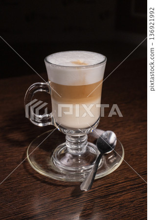 Latte in a glass cup on a wooden table 136921992