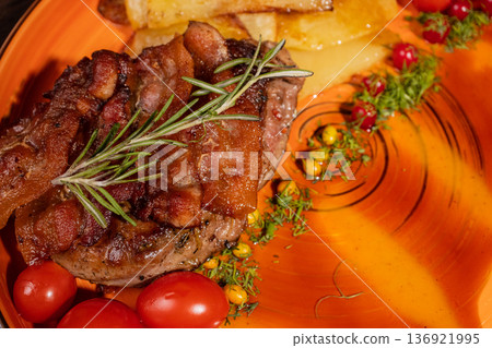 Fried potatoes with a piece of meat on a plate Fried potatoes with a piece of meat on a plate 136921995
