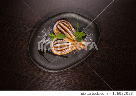 Dessert of fried pear sprinkled with powdered Dessert of fried pear sprinkled with powdered 136922038