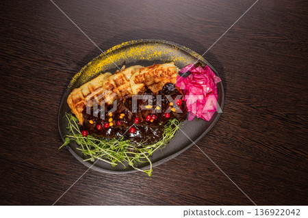 Fried meat with potato waffles and herbs on a 136922042