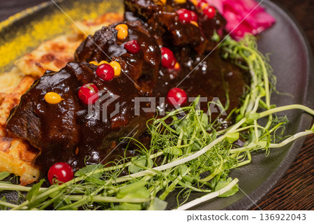 Fried meat with potato waffles and herbs on a Fried meat with potato waffles and herbs on a 136922043