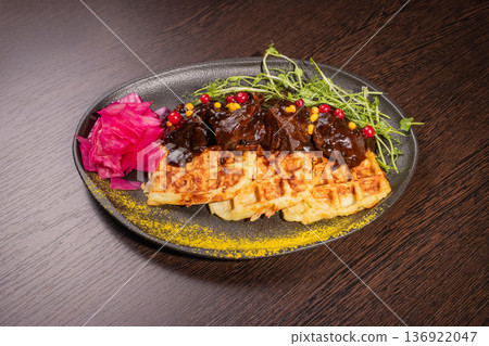 Fried meat with potato waffles and herbs on a Fried meat with potato waffles and herbs on a 136922047