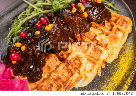 Fried meat with potato waffles and herbs on a Fried meat with potato waffles and herbs on a 136922048