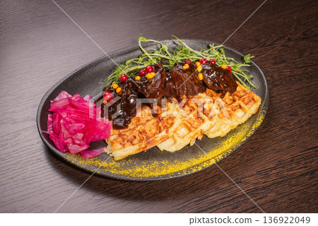 Fried meat with potato waffles and herbs on a Fried meat with potato waffles and herbs on a 136922049