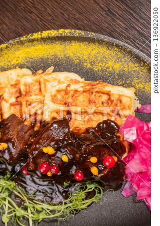 Fried meat with potato waffles and herbs on a Fried meat with potato waffles and herbs on a 136922050